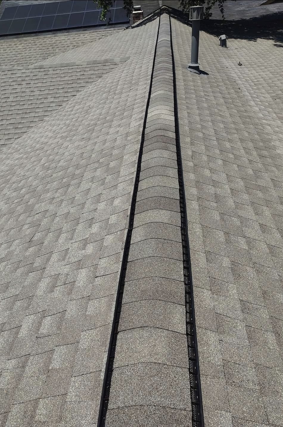 Metal roofing components and vents on a completed Houston roof